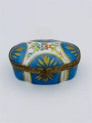 A hand painted porcelain box with gilt edging and clasp. See picture for makers mark.