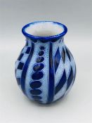 A small stoneware geometric patterned vase in blue.