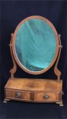 A Mahogany two drawer, oval toilet mirror.