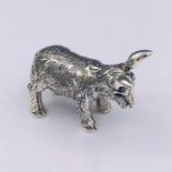 A silver figure of a donkey with ruby eyes