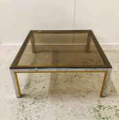 A Harrods Vintage brass and smoked glass coffee table.