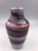 A Cobridge vase in Red and Mauve glaze