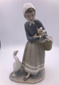 Lladro figure of a girl holding a basket with a goose by her feet