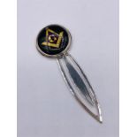 A silver bookmark with Masonic image