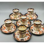 A set of six Copeland Spode coffee cans and saucers with hallmarked silver cup holders
