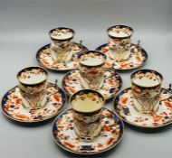 A set of six Copeland Spode coffee cans and saucers with hallmarked silver cup holders