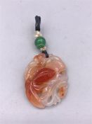 A Chinese Jade pendant with carp motif.