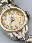 A ladies evening or dress watch, marked 14ct Solid Gold to back with gold plated strap.