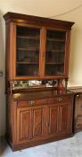 A Mahogany bookcase with mirrored back.