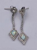 A Pair of Silver CZ and Opal Paneled drop earrings