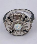 A Silver Art Deco style ring set with CZ and central Opal panel.