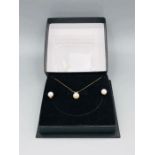 A Pearl set to include earrings and necklace in 9ct yellow gold setting.