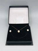 A Pearl set to include earrings and necklace in 9ct yellow gold setting.