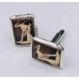 A Pair of silver and enamel set cufflinks with nude scenes