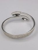 A silver bangle, Artisan made from silver spoons