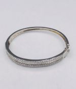 A Substantial silver and CZ bangle
