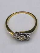 An 18ct yellow gold three stone diamond ring