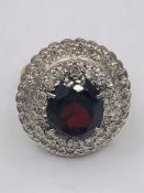 A Yellow gold impressive garnet and diamond double halo ring