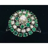 An 18ct white gold emerald and diamond halo style ring of 1.2ct's approx.