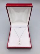 An 18ct White Gold diamond pendant necklace on gold chain.