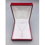 An 18ct White Gold diamond pendant necklace on gold chain.