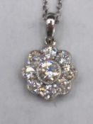 An 18ct white gold diamond daisy style pendant necklace of 1/2ct