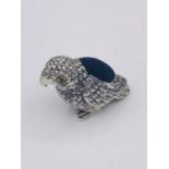 A silver parrot pincushion