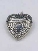 A Silver Heart shaped pocket with embossed decoration