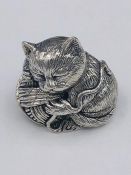 A Sterling Silver figure of a seated cat.