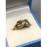 A 9ct gold and diamond cross over ring