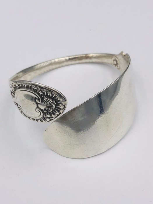 A Hallmarked silver bangle, made by Artisan from silver cutlery..