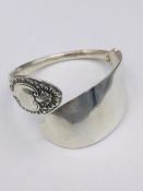 A Hallmarked silver bangle, made by Artisan from silver cutlery..