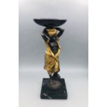 A Figure of a woman carrying a basket, bronze.