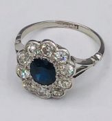 A Sapphire and Diamond Daisy ring on a platinum band (4.1g)