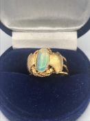 An Opal Arts and Crafts ring, 14ct setting