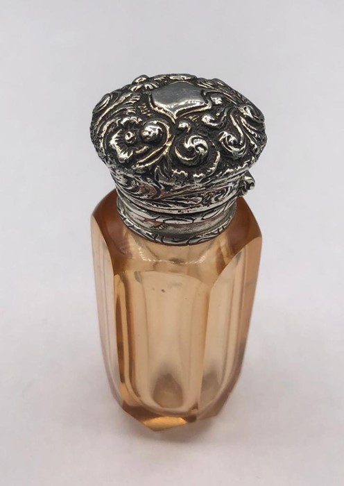 A silver glass perfume bottle with Vinaigrette style lid