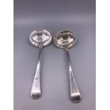 A Pair of silver sauce ladles.