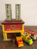A 1970's Fisher Price Fire Station with associated items