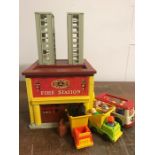 A 1970's Fisher Price Fire Station with associated items