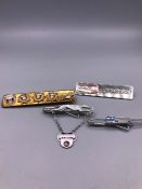 A selection of Greyhound Bus Driver medals, long service awards and name badges.