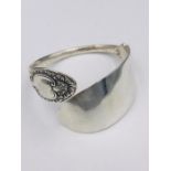 A Hallmarked silver bangle, made by Artisan from silver cutlery..