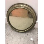 A Brass porthole style mirror with etched design. AF