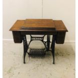 A Singer Sewing Machine Table with Sewing machine.