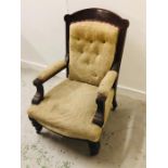 A Mahogany Victorian armchair with carved back and button back upholstery.