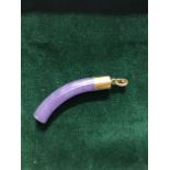 A Lavender Jade pendant on a gold setting