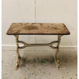 A Cast iron table, in white with wooden top.