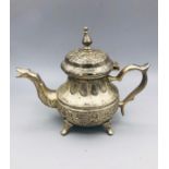 A white metal Persian teapot