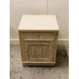 A Cream painted bedside cabinet with glass handles.