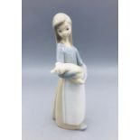 A Lladro figure of Lady carrying a pig