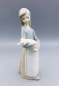 A Lladro figure of Lady carrying a pig